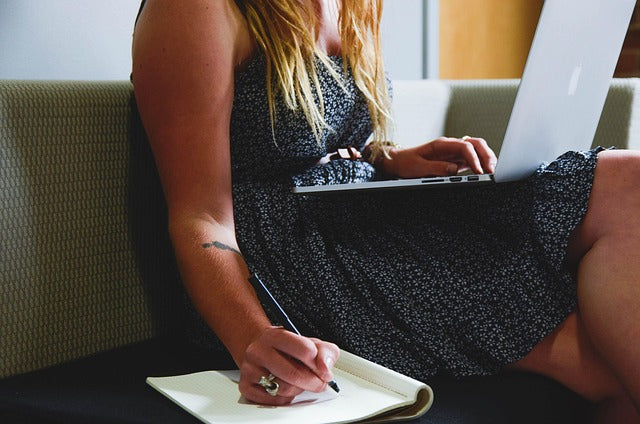 person writing an article with help from computer